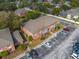 Aerial view of a red brick apartment complex featuring mature trees and parking at 562 Flemming Way # 200, Maitland, FL 32751