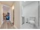 Hallway leading to the bathroom and laundry with a vanity and toilet at 562 Flemming Way # 200, Maitland, FL 32751