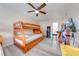 Spacious bedroom featuring two sets of wooden bunk beds, ceiling fan, and arcade game area at 562 Flemming Way # 200, Maitland, FL 32751