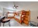 Bedroom with wooden bunk beds, matching built in staircase, and a ceiling fan with overhead lighting at 562 Flemming Way # 200, Maitland, FL 32751