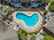 Aerial view of community pool surrounded by lush greenery, decks, and patios at 562 Flemming Way # 200, Maitland, FL 32751