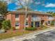 Charming red brick two-story home featuring a balcony and covered patio at 562 Flemming Way # 200, Maitland, FL 32751