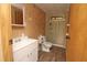 Bathroom featuring a stand-alone sink, toilet, and walk-in shower with glass doors at 6332 Bayberry Ne Blvd, Winter Haven, FL 33881