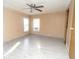 Bedroom featuring wood-look tile floors, ceiling fan, and two windows with mini-blinds at 6332 Bayberry Ne Blvd, Winter Haven, FL 33881