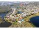 Aerial view of the community featuring multiple ponds, lush landscaping, and amenities like a pool and playground at 6410 Cherry Grove Cir, Orlando, FL 32809