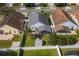 An aerial view showcases the home's backyard, privacy fence, screened in porch and proximity to neighbors at 6410 Cherry Grove Cir, Orlando, FL 32809