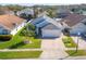 Aerial view of home showcasing well-manicured lawn and mature tropical landscaping at 6410 Cherry Grove Cir, Orlando, FL 32809