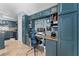 Well-designed kitchen desk area with stainless appliances, granite counters, tile floor, and blue cabinetry at 6410 Cherry Grove Cir, Orlando, FL 32809