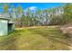 An expansive, lush backyard bordered by towering trees at 6430 Sw 144Th Street Rd, Ocala, FL 34473