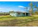 Inviting backyard with lush green grass, perfect for outdoor entertaining and relaxation in a serene setting at 6430 Sw 144Th Street Rd, Ocala, FL 34473