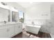 Modern bathroom with soaking tub, double vanity, and marble accents at 6430 Sw 144Th Street Rd, Ocala, FL 34473