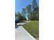 Side view of the house showcasing a partially brick paved driveway extension at 6430 Sw 144Th Street Rd, Ocala, FL 34473
