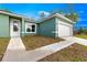 Lovely, bright home featuring a one car garage, and manicured lawn under a beautiful blue sky at 6430 Sw 144Th Street Rd, Ocala, FL 34473