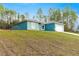 This home sits atop a green hill and features a two-car garage at 6430 Sw 144Th Street Rd, Ocala, FL 34473