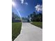 Charming single-story home features a lush green lawn, a long driveway, and a two-car garage at 6430 Sw 144Th Street Rd, Ocala, FL 34473