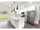 Modern kitchen with stainless steel appliances, an island with sink and counter seating, and white cabinetry at 6430 Sw 144Th Street Rd, Ocala, FL 34473