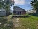 View of a well-maintained backyard, complete with a deck and partial fencing at 713 Illinois Ave, St Cloud, FL 34769