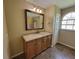 Bathroom featuring a vanity with a large framed mirror, and a shower-tub combo at 713 Illinois Ave, St Cloud, FL 34769