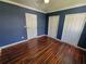 Classic bedroom with two closets, wood floors, and a ceiling fan at 713 Illinois Ave, St Cloud, FL 34769