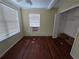 Bright bedroom with hardwood floors and a closet for storage at 713 Illinois Ave, St Cloud, FL 34769