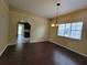 Traditional dining room with laminate flooring, a chandelier, and an archway to the living area at 713 Illinois Ave, St Cloud, FL 34769