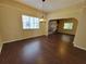 Light-filled dining room with laminate flooring, a chandelier, and an open archway into the living area at 713 Illinois Ave, St Cloud, FL 34769