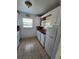 A functional kitchen with tile flooring, white cabinetry, and essential appliances at 713 Illinois Ave, St Cloud, FL 34769