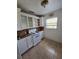 A functional kitchen with tile flooring, white cabinetry, and essential appliances at 713 Illinois Ave, St Cloud, FL 34769