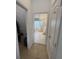 View through the bedroom to the main bathroom, featuring a glass shower and soaking tub at 723 Tuscan Hills Blvd, Davenport, FL 33897