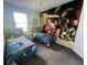 Bright bedroom with two twin beds and a large Toy Story mural at 723 Tuscan Hills Blvd, Davenport, FL 33897