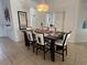 Dining table with seating for six and tiled floors at 723 Tuscan Hills Blvd, Davenport, FL 33897