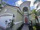 Inviting home exterior featuring a terracotta tile roof, arched entry, and a brick-paved walkway at 723 Tuscan Hills Blvd, Davenport, FL 33897