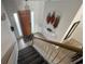 Hallway features stairs, tile flooring, decorative wall fixture, and a painted front door at 723 Tuscan Hills Blvd, Davenport, FL 33897