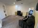 Bright living room features carpet, a ceiling fan, TV and black sofa at 723 Tuscan Hills Blvd, Davenport, FL 33897