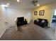 Bright living room features carpet, a ceiling fan, TV and black sofa at 723 Tuscan Hills Blvd, Davenport, FL 33897