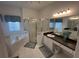 The main bathroom offers a glass shower, soaking tub, dual sinks, and bright natural light at 723 Tuscan Hills Blvd, Davenport, FL 33897