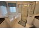 This bathroom is equipped with a tub and separate shower at 723 Tuscan Hills Blvd, Davenport, FL 33897