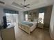 Relaxing main bedroom with tray ceiling, fan, and ensuite bath at 723 Tuscan Hills Blvd, Davenport, FL 33897