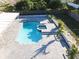 Aerial view of the pool and paver patio surrounded by tropical landscaping and privacy fence at 7860 Kensingham Ct, Orlando, FL 32835