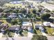 Expansive aerial view of a residential neighborhood featuring homes, streets, and community amenities at 7860 Kensingham Ct, Orlando, FL 32835