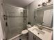 Bathroom featuring glass shower doors, light gray walls, a white vanity, and tiled floors at 7860 Kensingham Ct, Orlando, FL 32835