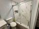 Bathroom featuring a glass shower and white marble, a toilet, and a storage nook at 7860 Kensingham Ct, Orlando, FL 32835