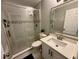 Bathroom featuring glass shower doors, light gray walls, a white vanity, and tiled floors at 7860 Kensingham Ct, Orlando, FL 32835