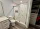 Bathroom featuring a glass shower and white marble, a toilet, and a storage nook at 7860 Kensingham Ct, Orlando, FL 32835