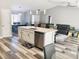 Bright open concept kitchen features an island, stainless steel appliances, and seamless transition into the living area at 7860 Kensingham Ct, Orlando, FL 32835