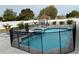 Private pool with fence, surrounded by pavers, featuring an attached hot tub and tropical landscaping at 7860 Kensingham Ct, Orlando, FL 32835