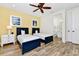 Nautical-themed bedroom with two beds, ceiling fan, and ensuite bath at 8165 Surf St, Kissimmee, FL 34747