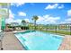 Private pool and hot tub area with ample seating and lush landscaping, perfect for relaxation and entertainment at 8165 Surf St, Kissimmee, FL 34747