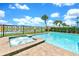 Inviting pool and hot tub offer a relaxing retreat, complemented by serene pond views and lush landscaping at 8165 Surf St, Kissimmee, FL 34747