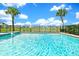 Sparkling in-ground pool overlooks a scenic pond, surrounded by lush greenery and community homes at 8165 Surf St, Kissimmee, FL 34747